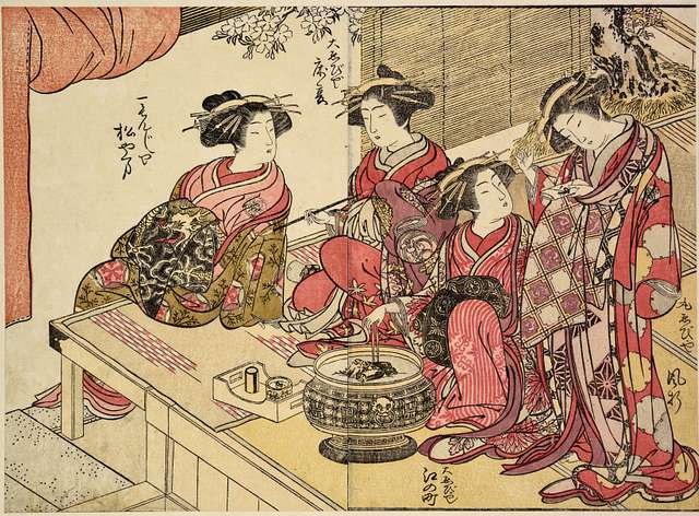 A group of five Japanese women gathered on the veranda of a house for hanami. They are likely enjoying the beauty of the cherry blossoms together.